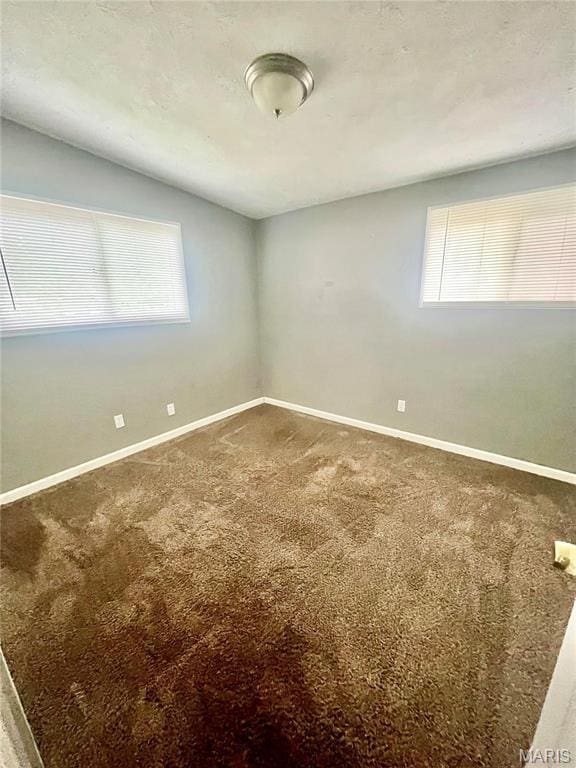750 Robinwood Dr, Florissant, MO 63033 - carpeted empty room with healthy amount of natural light
