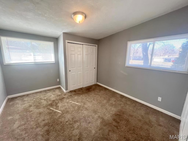 750 Robinwood Dr, Florissant, MO 63033 - unfurnished bedroom with multiple windows, a closet, and carpet flooring
