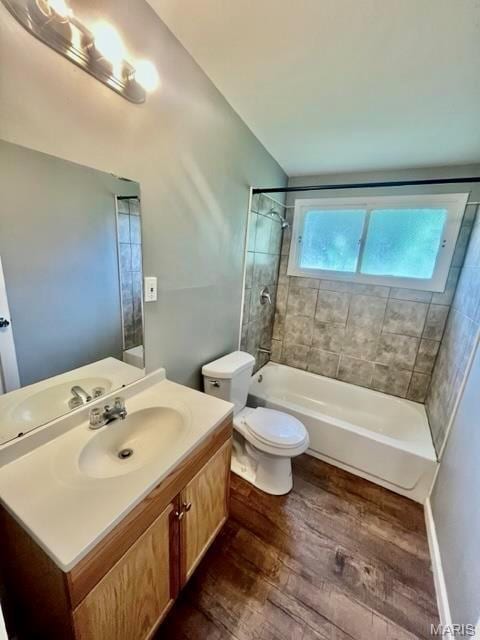750 Robinwood Dr, Florissant, MO 63033 - bathroom with wood finished floors, vanity, and  shower combination
