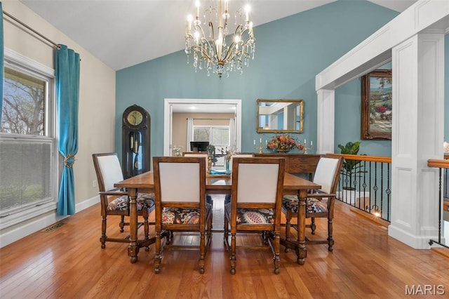 149 Windy Point Ave, Cape Girardeau, MO 63701 - dining room with hardwood / wood-style flooring, vaulted ceiling, a chandelier, and baseboards