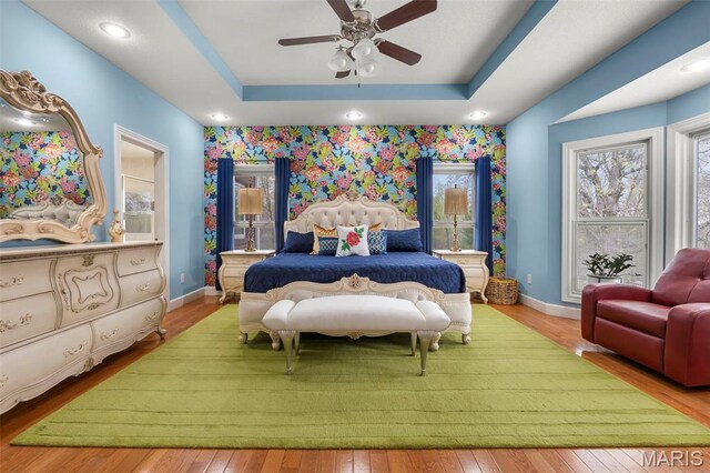 149 Windy Point Ave, Cape Girardeau, MO 63701 - bedroom with baseboards, hardwood / wood-style floors, a raised ceiling, and a ceiling fan