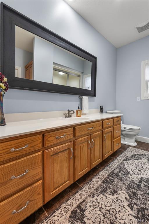 149 Windy Point Ave, Cape Girardeau, MO 63701 - bathroom featuring toilet, vanity, and baseboards