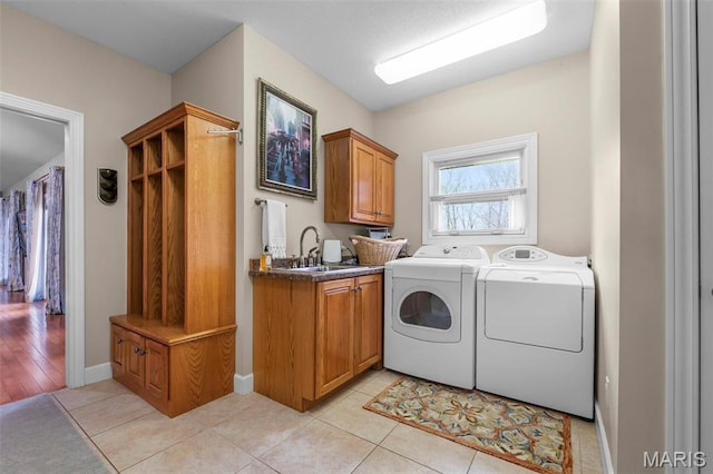 149 Windy Point Ave, Cape Girardeau, MO 63701 - washroom with washer and dryer, cabinet space, light tile patterned floors, and baseboards