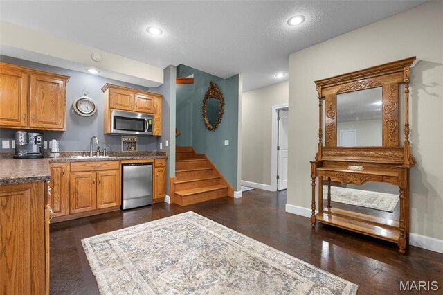 149 Windy Point Ave, Cape Girardeau, MO 63701 - kitchen featuring stainless steel appliances, baseboards, recessed lighting, brown cabinets, and a textured ceiling