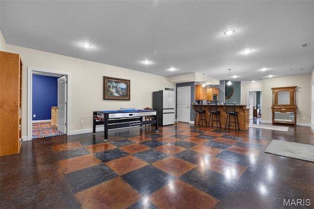 149 Windy Point Ave, Cape Girardeau, MO 63701 - kitchen featuring freestanding refrigerator, recessed lighting, brown cabinetry, baseboards, and a breakfast bar area