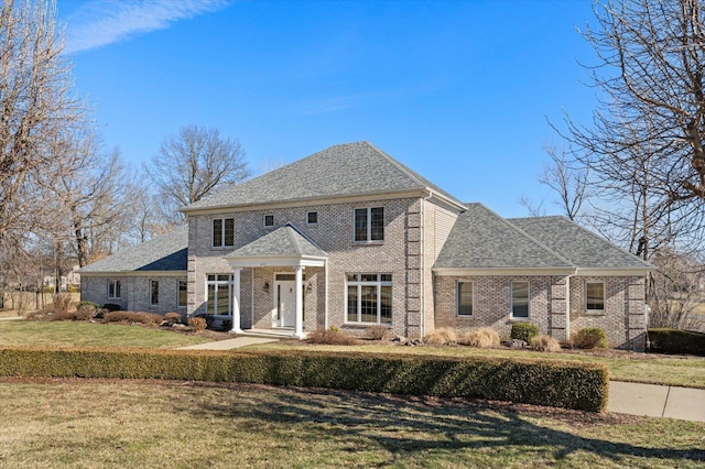 230 W Waters Edge Dr, Belleville, IL 62221 - colonial-style house with brick siding, a front yard, and a shingled roof