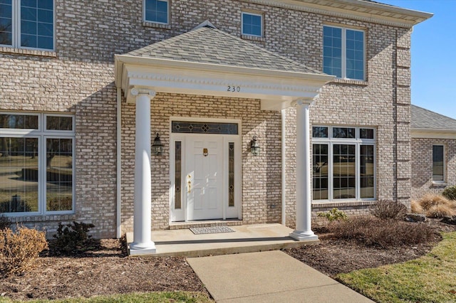 230 W Waters Edge Dr, Belleville, IL 62221 - property entrance with a shingled roof, brick siding, and covered porch