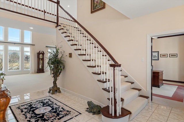 230 W Waters Edge Dr, Belleville, IL 62221 - stairway with a high ceiling, marble finish floors, and baseboards