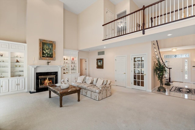 230 W Waters Edge Dr, Belleville, IL 62221 - carpeted living room featuring a high ceiling, a premium fireplace, baseboards, and built in features