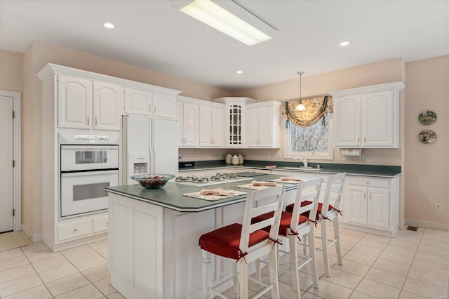 230 W Waters Edge Dr, Belleville, IL 62221 - kitchen featuring white appliances, light tile patterned floors, a sink, white cabinets, and recessed lighting