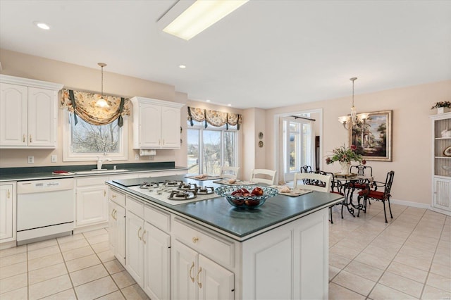 230 W Waters Edge Dr, Belleville, IL 62221 - kitchen with white appliances, dark countertops, a sink, light tile patterned floors, and pendant lighting