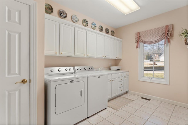 230 W Waters Edge Dr, Belleville, IL 62221 - laundry room featuring cabinet space, washing machine and dryer, baseboards, and light tile patterned flooring