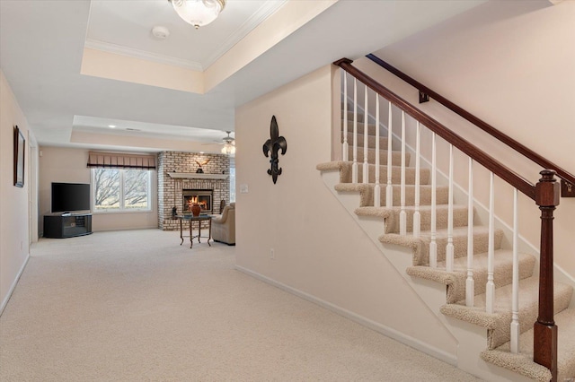 230 W Waters Edge Dr, Belleville, IL 62221 - stairs featuring a fireplace, a raised ceiling, carpet floors, a ceiling fan, and baseboards