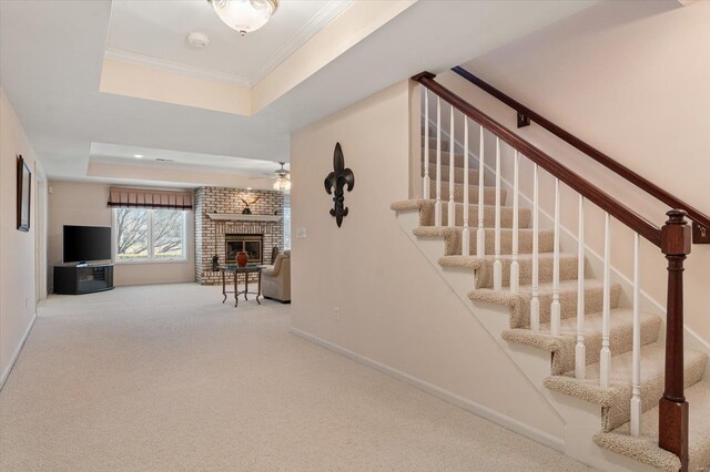 230 W Waters Edge Dr, Belleville, IL 62221 - stairway with a raised ceiling, a brick fireplace, ceiling fan, carpet floors, and baseboards