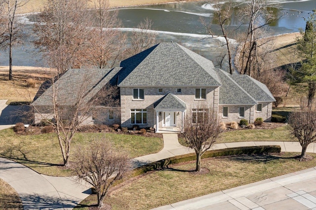 230 W Waters Edge Dr, Belleville, IL 62221 - view of front facade featuring a water view, a front yard, and a shingled roof