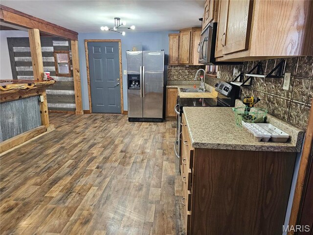 18480 State Route O, Rolla, MO 65401 - kitchen featuring stainless steel appliances, a sink, light wood-style flooring, tasteful backsplash, and a chandelier