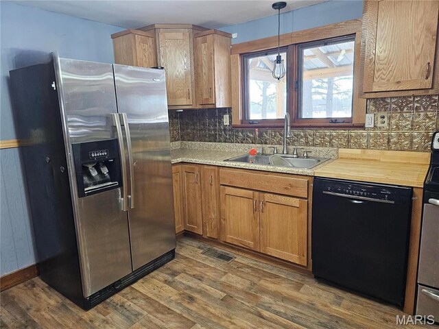 18480 State Route O, Rolla, MO 65401 - kitchen with black dishwasher, stainless steel refrigerator with ice dispenser, a sink, and dark wood-style flooring