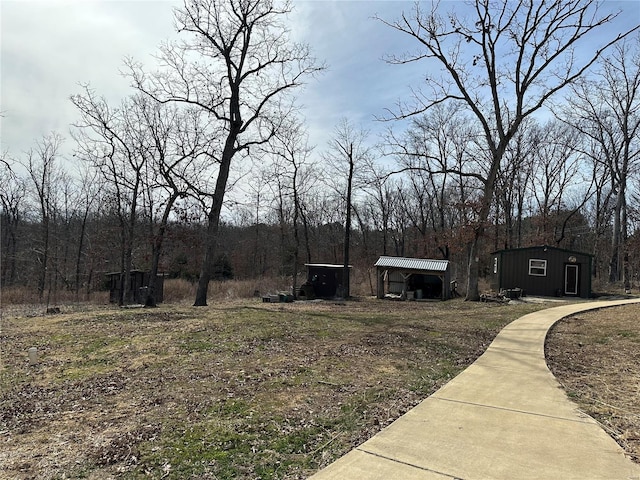 view of front of home with an outbuilding, metal roof, and a detached carport
