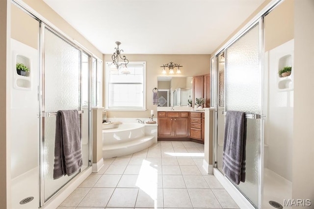 full bath featuring a shower stall, tile patterned flooring, vanity, and a bath