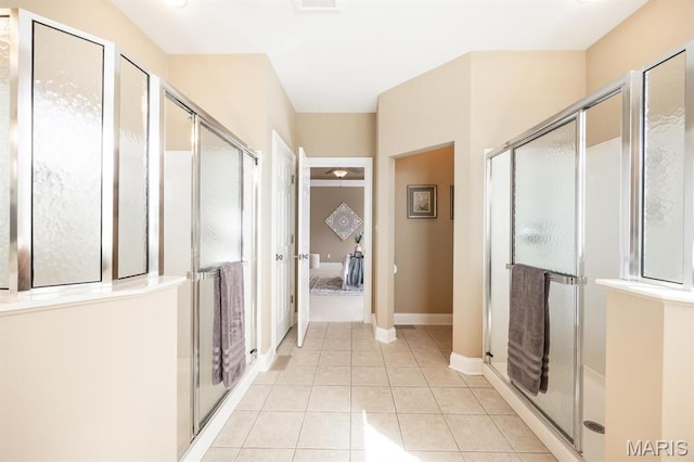 full bath with tile patterned flooring and a shower stall