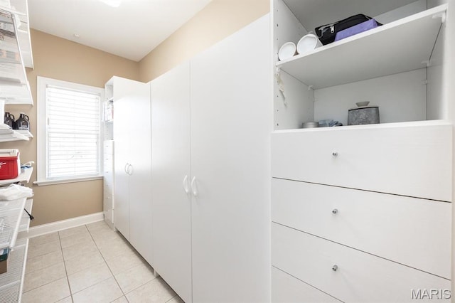 walk in closet with light tile patterned flooring
