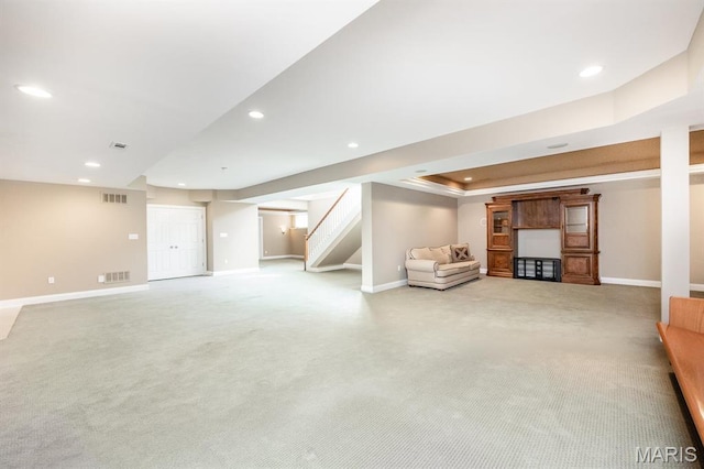 finished basement with recessed lighting, baseboards, stairway, and carpet flooring