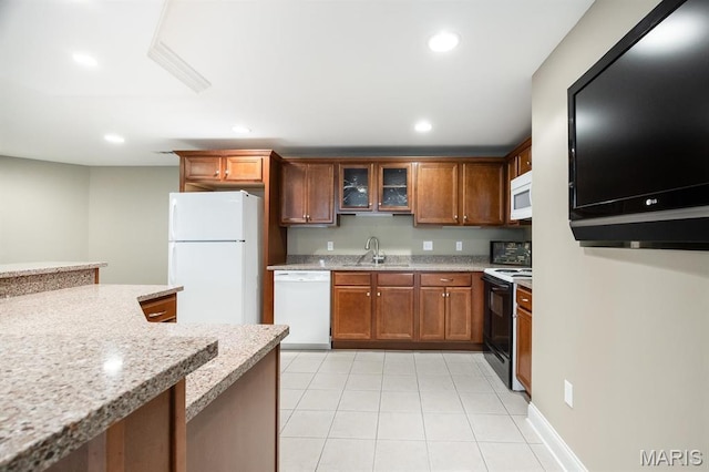 kitchen featuring white appliances, a sink, light tile patterned flooring, glass insert cabinets, and recessed lighting
