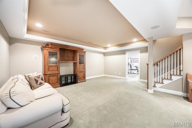 living area featuring a tray ceiling, light colored carpet, baseboards, and recessed lighting