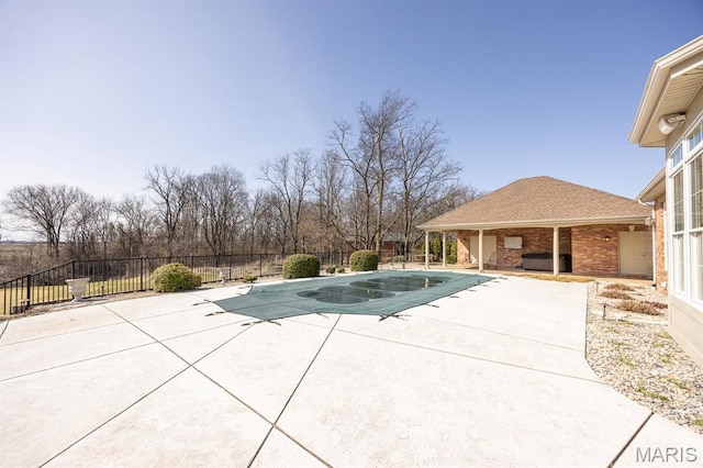 view of pool with a patio and fence