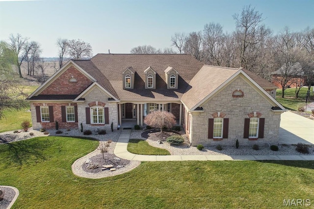 view of front of home featuring stone siding, a front lawn, and a shingled roof
