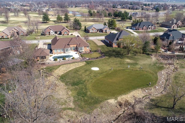 aerial view of property's location with nearby suburban area and a nearby body of water