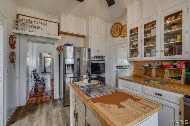 401 S Main, Fredericktown, MO 63645 - kitchen with stainless steel fridge with ice dispenser, butcher block countertops, white cabinetry, ornamental molding, and wood finished floors