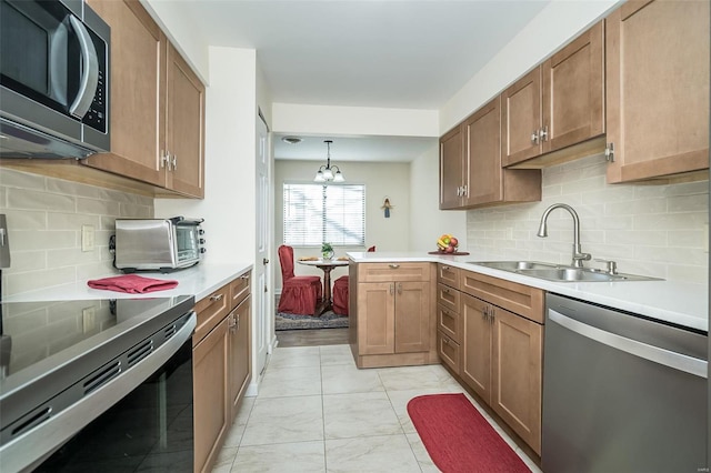 1611 Walpole Dr Unit C, Chesterfield, MO 63017 - kitchen featuring stainless steel appliances, a sink, light countertops, backsplash, and a peninsula