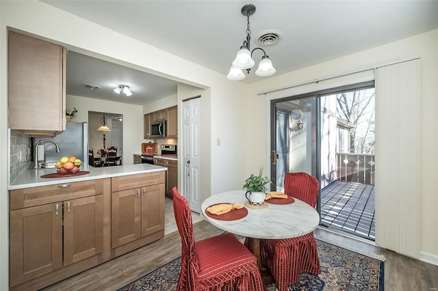 1611 Walpole Dr Unit C, Chesterfield, MO 63017 - dining room with wood finished floors and a chandelier