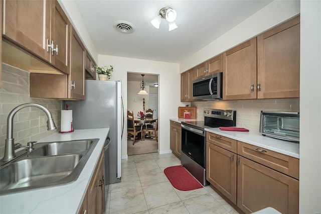 1611 Walpole Dr Unit C, Chesterfield, MO 63017 - kitchen with appliances with stainless steel finishes, a sink, tasteful backsplash, and light marble finish floors
