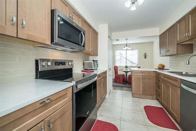 1611 Walpole Dr Unit C, Chesterfield, MO 63017 - kitchen with appliances with stainless steel finishes, a sink, light marble finish flooring, tasteful backsplash, and light countertops