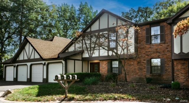1611 Walpole Dr Unit C, Chesterfield, MO 63017 - tudor-style house featuring an attached garage, brick siding, and driveway