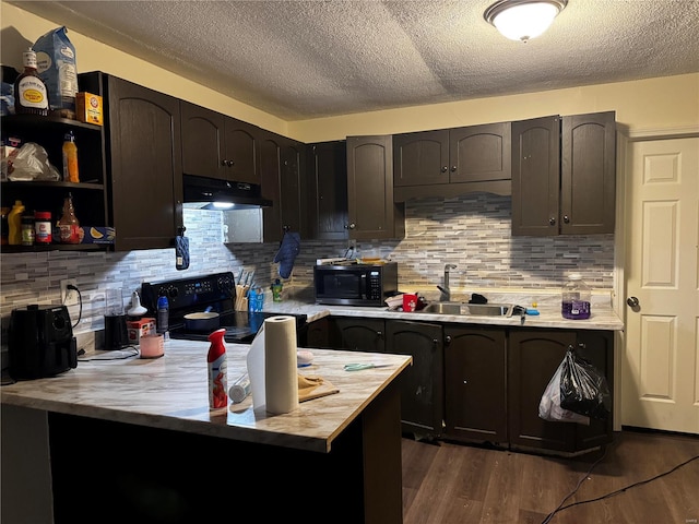 10533 Earl Dr, Saint Louis, MO 63136 - kitchen featuring black appliances, a sink, under cabinet range hood, light countertops, and a textured ceiling