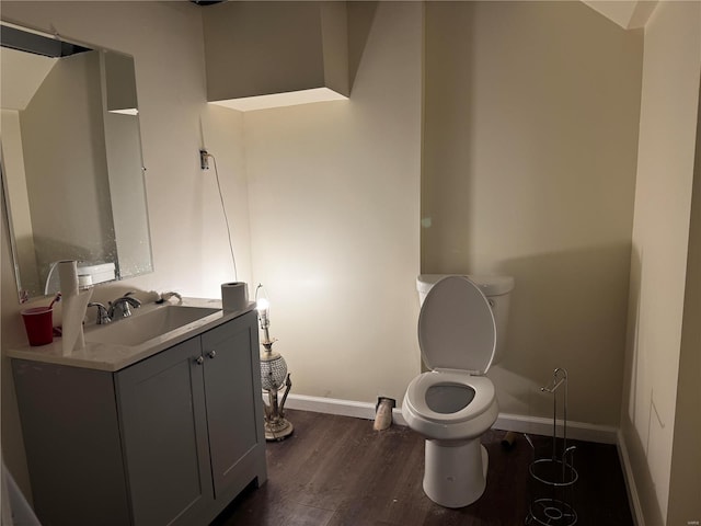 10533 Earl Dr, Saint Louis, MO 63136 - bathroom with wood finished floors, baseboards, toilet, and vanity