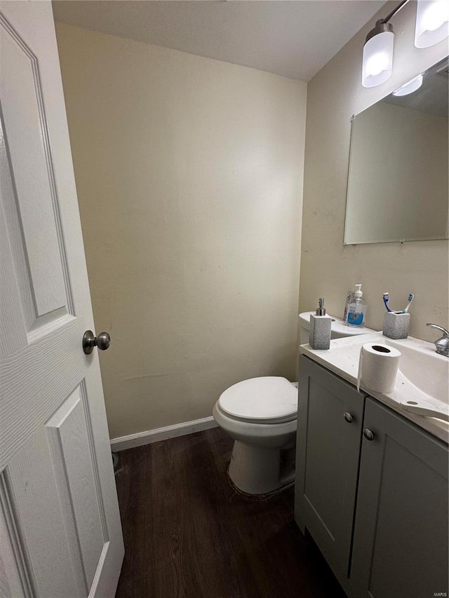 10533 Earl Dr, Saint Louis, MO 63136 - bathroom with wood finished floors, toilet, vanity, and baseboards