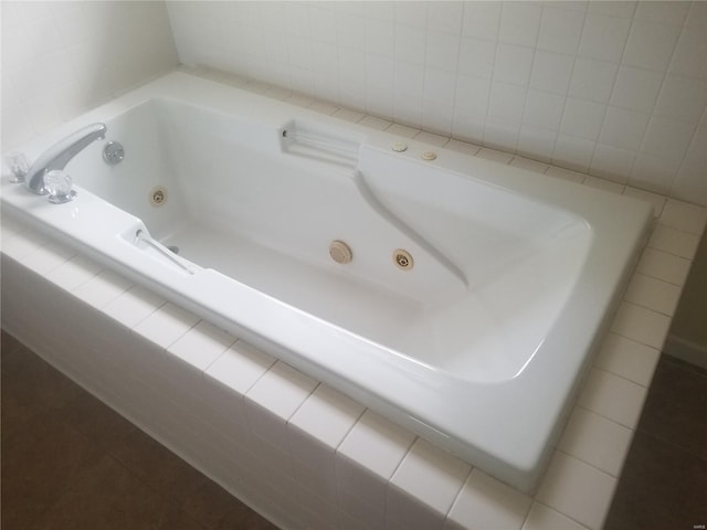 bathroom featuring a whirlpool tub and tile patterned floors