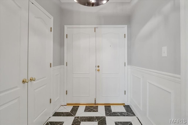 561 Sarah Ln Unit 305, Saint Louis, MO 63141 - doorway featuring a decorative wall, dark tile patterned flooring, and wainscoting