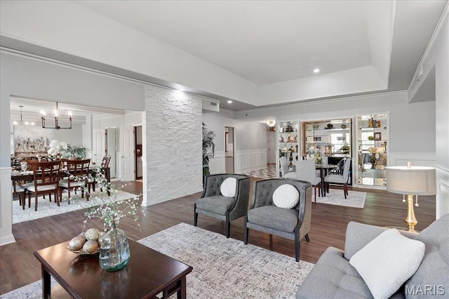 561 Sarah Ln Unit 305, Saint Louis, MO 63141 - living room with wood finished floors, wainscoting, a tray ceiling, and a chandelier