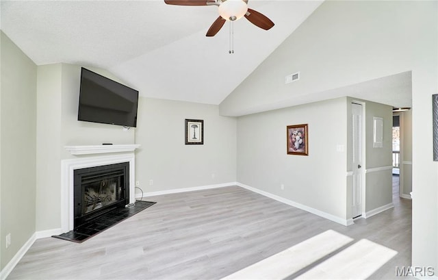 9167 Robin Ct, Saint Louis, MO 63144 - unfurnished living room with wood finished floors, ceiling fan, a fireplace, baseboards, and high vaulted ceiling