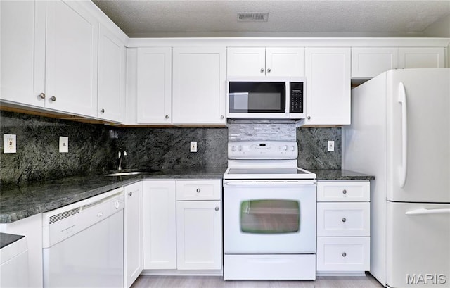 9167 Robin Ct, Saint Louis, MO 63144 - kitchen with white appliances, a sink, white cabinets, backsplash, and dark stone countertops