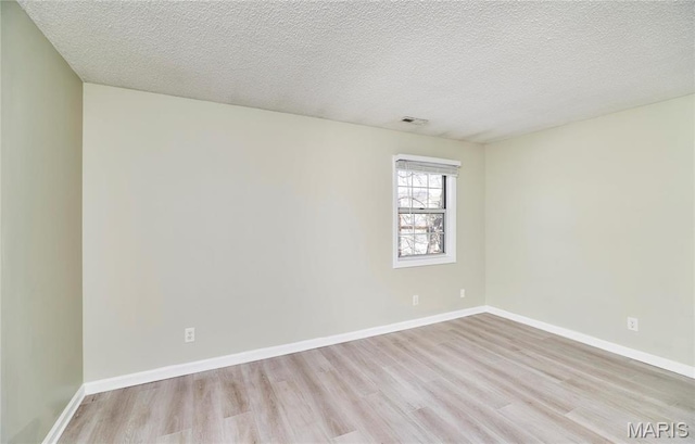 9167 Robin Ct, Saint Louis, MO 63144 - spare room with light wood-type flooring, baseboards, and a textured ceiling