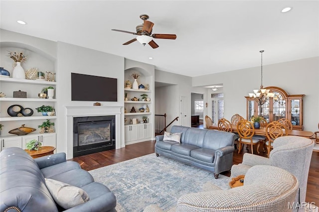 2 Wyndemere Ct, Lake St Louis, MO 63367 - living room with dark wood-style floors, a chandelier, ceiling fan, a glass covered fireplace, and recessed lighting