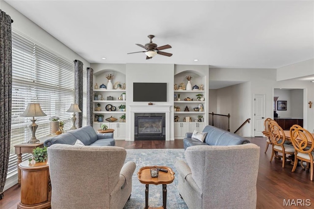 2 Wyndemere Ct, Lake St Louis, MO 63367 - living room featuring a ceiling fan, wood finished floors, a glass covered fireplace, built in shelves, and recessed lighting