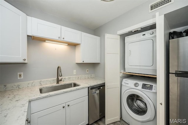 washroom featuring stacked washing machine and dryer and wood finished floors