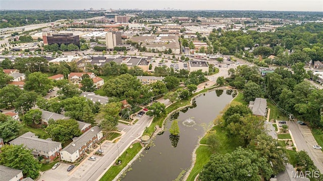 aerial view of property and surrounding area with a nearby body of water